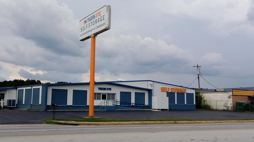 Tigers Eye Self Storage Greenwood from corner showing office and front of building with Street sign full length